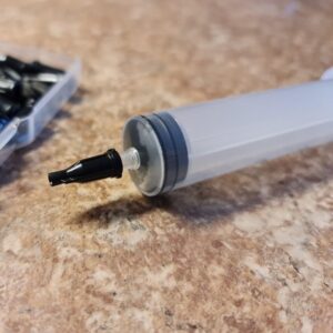 Luer lock cap on Luer slip syringe